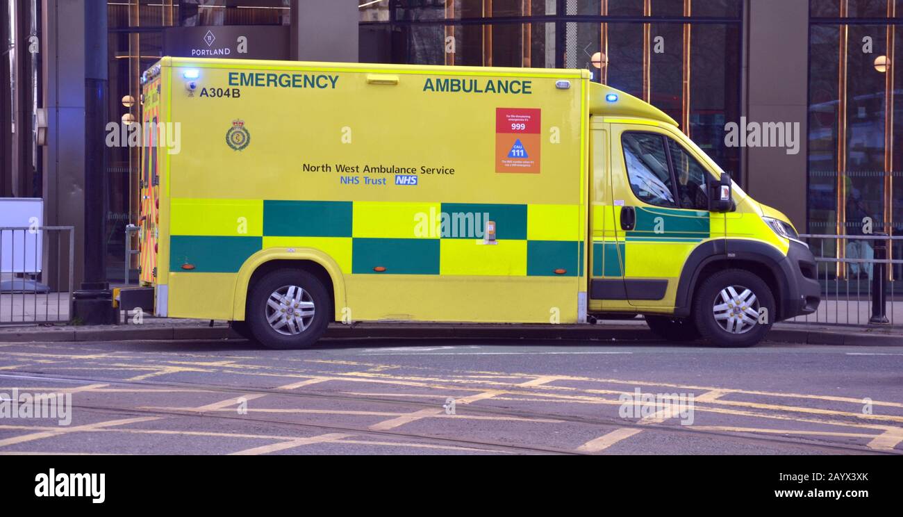 A North West Ambulance Service ambulance, with lights flashing, in