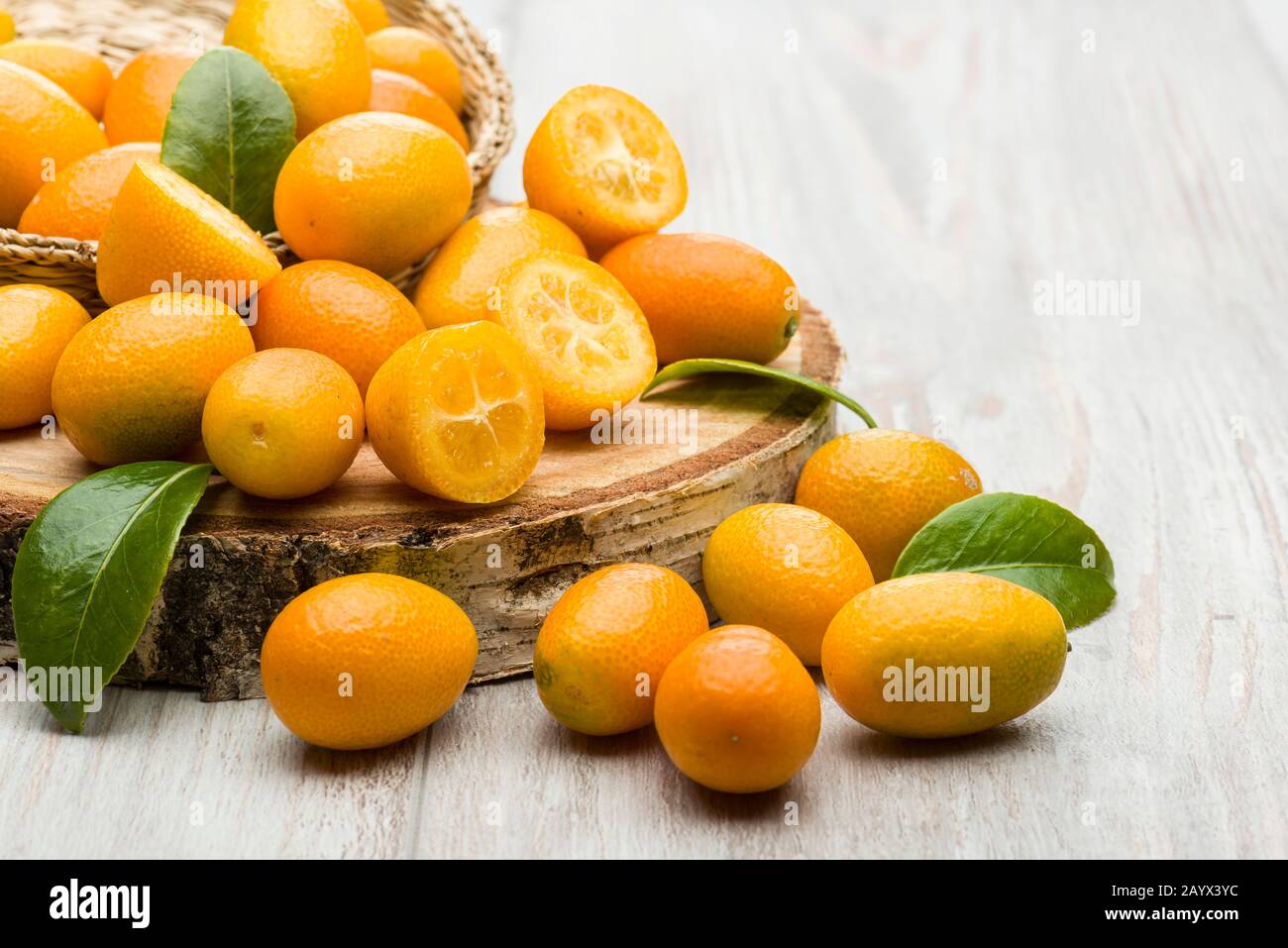 Pile of kumquat fruits, chinese tangerines, on wooden table. Stock Photo