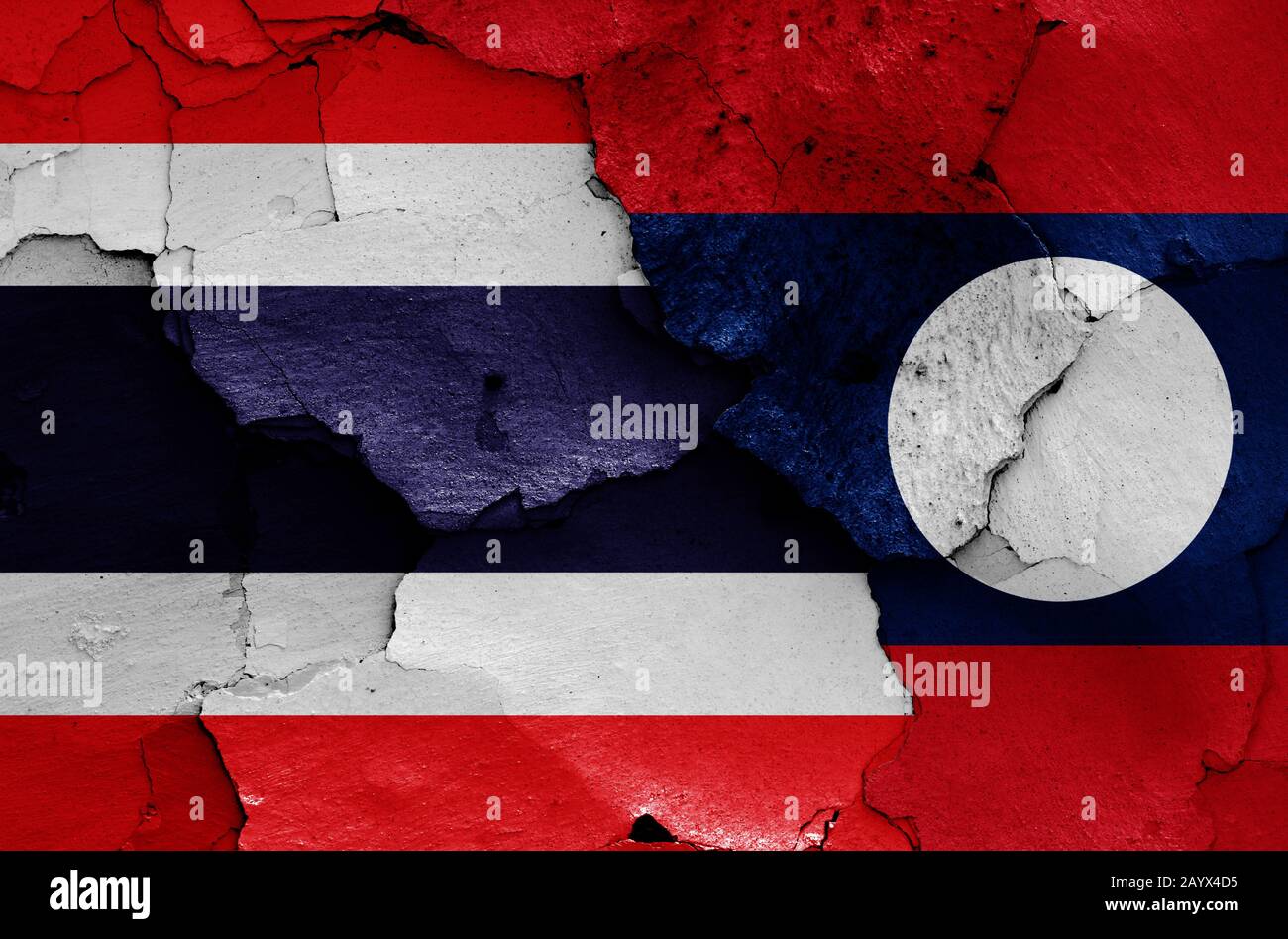 flags of Thailand and Laos painted on cracked wall Stock Photo
