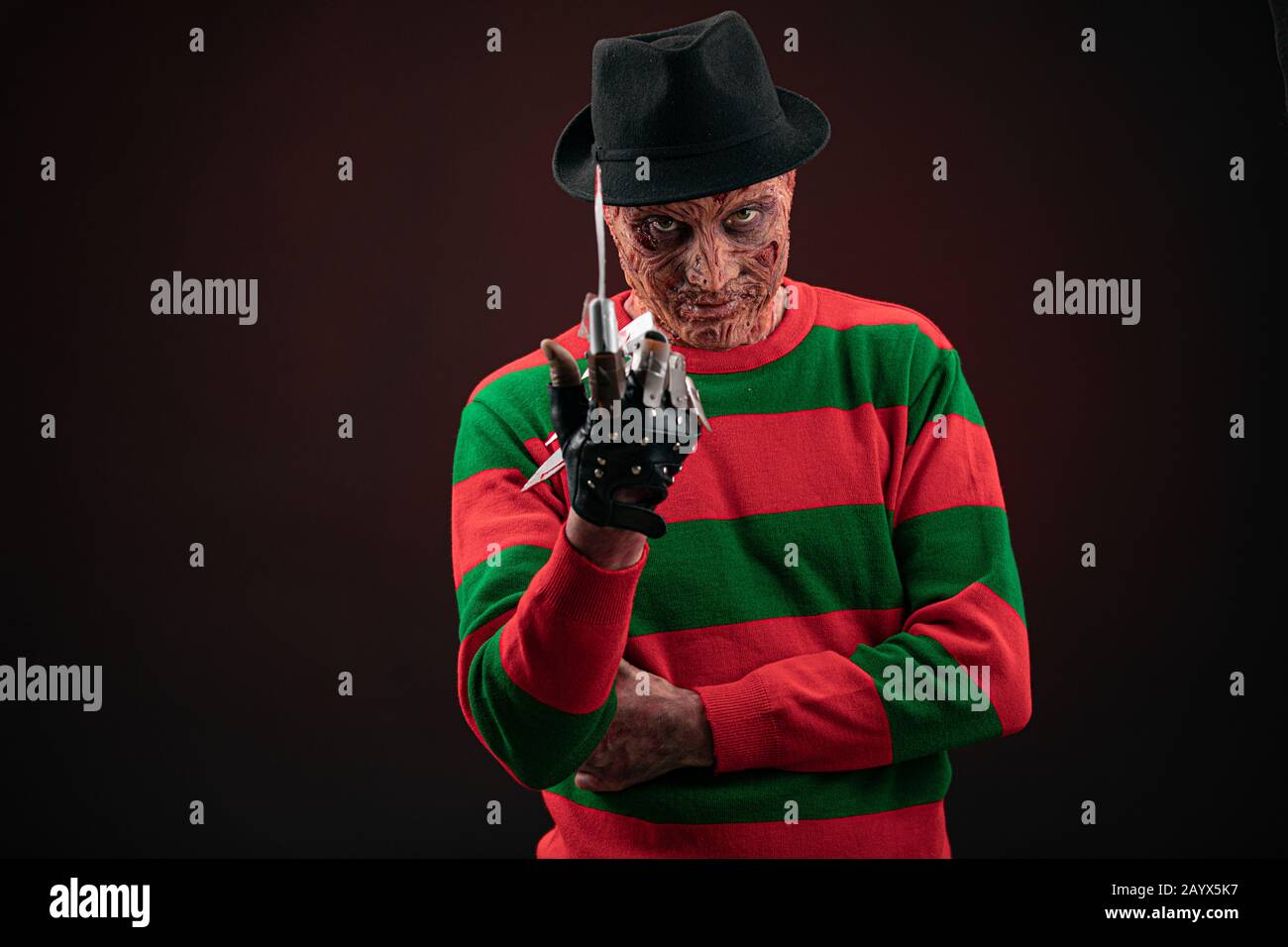 portrait of a man with a scary face and metal claws. Grimm hero for a horror movie. Freddy Krueger. 06 February 2020 Ukraine, Kyiv. make-up Stock Photo
