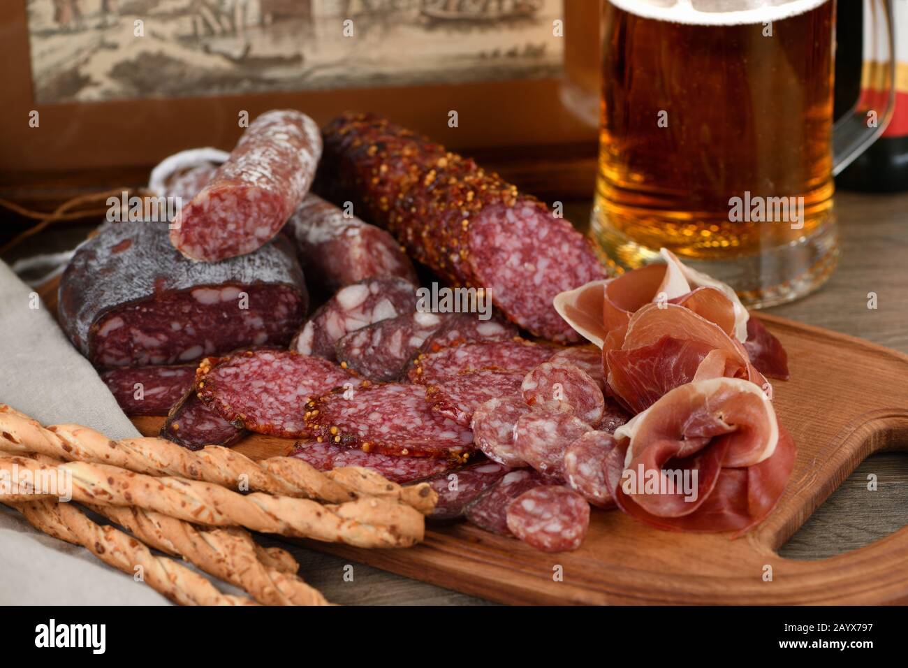 Antipasti dish with bacon, jerky, salami, crispy grissini with cheese