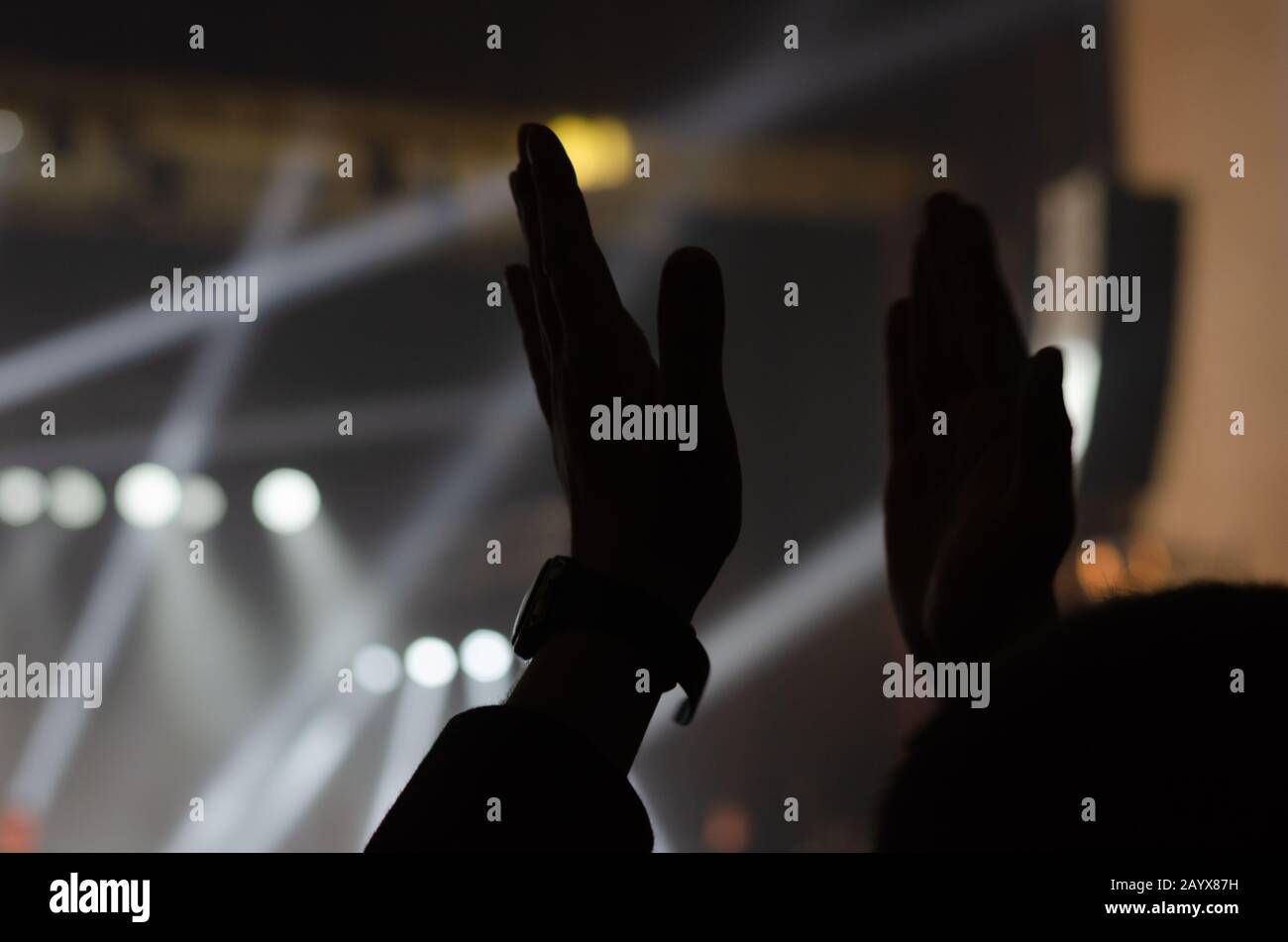 Close-up of male clapping hands at a music concert. Shooting from the ...