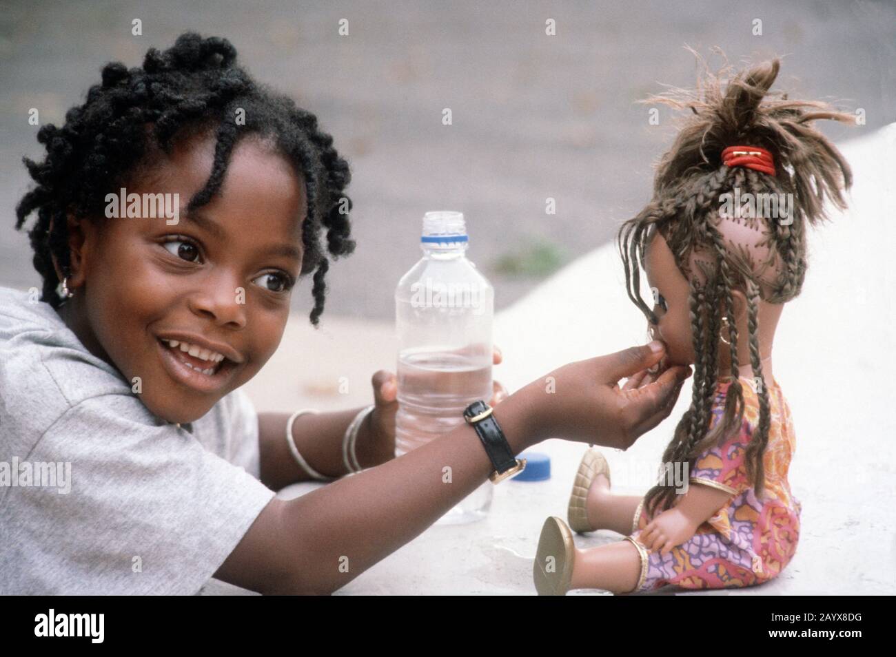 Small girl playing with her doll Stock Photo - Alamy