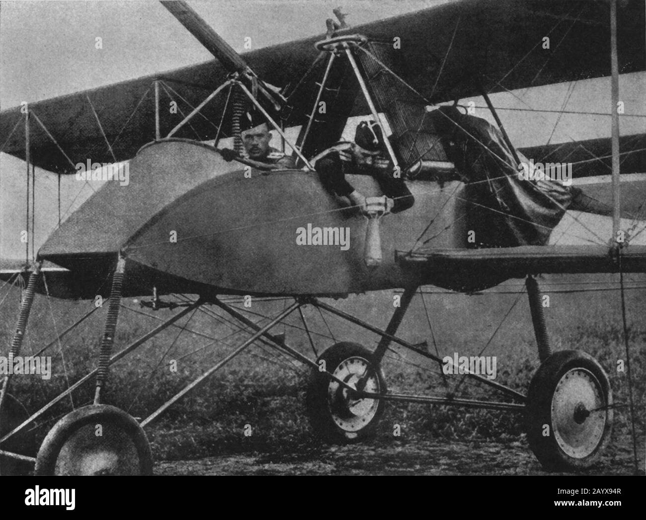 Russian aviators in French built Voisin III biplane bomber with one of the crew posing with a bomb on the Eastern front in Russia circa 1916 Stock Photo