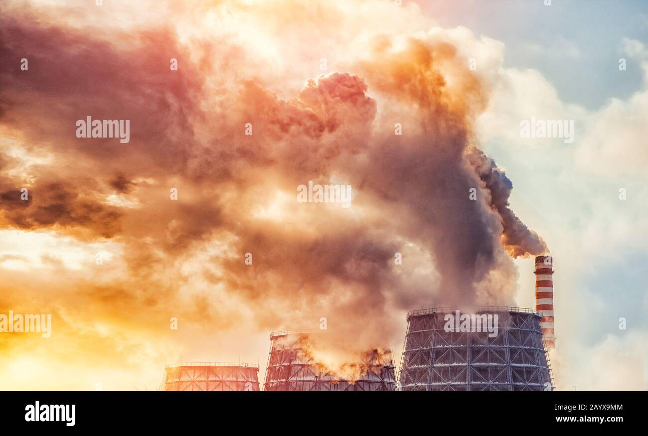 Air pollution smog from power factory plant chimneys smoking pipe sunset. Concept industry environmental problems Stock Photo