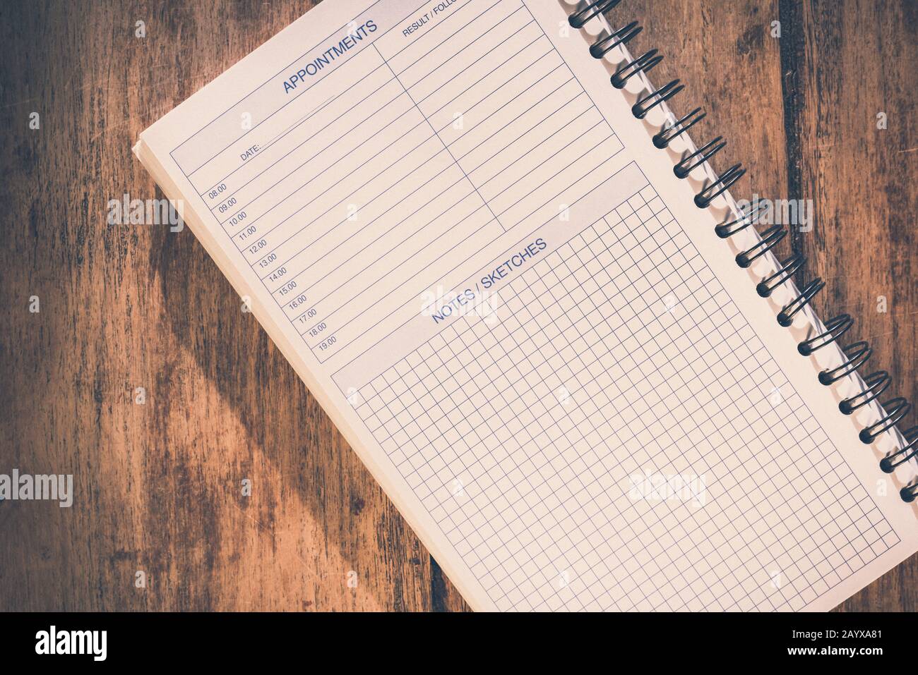 Office table concept. Blank notebook with appointments list and notes/sketches section. Retro look. Stock Photo
