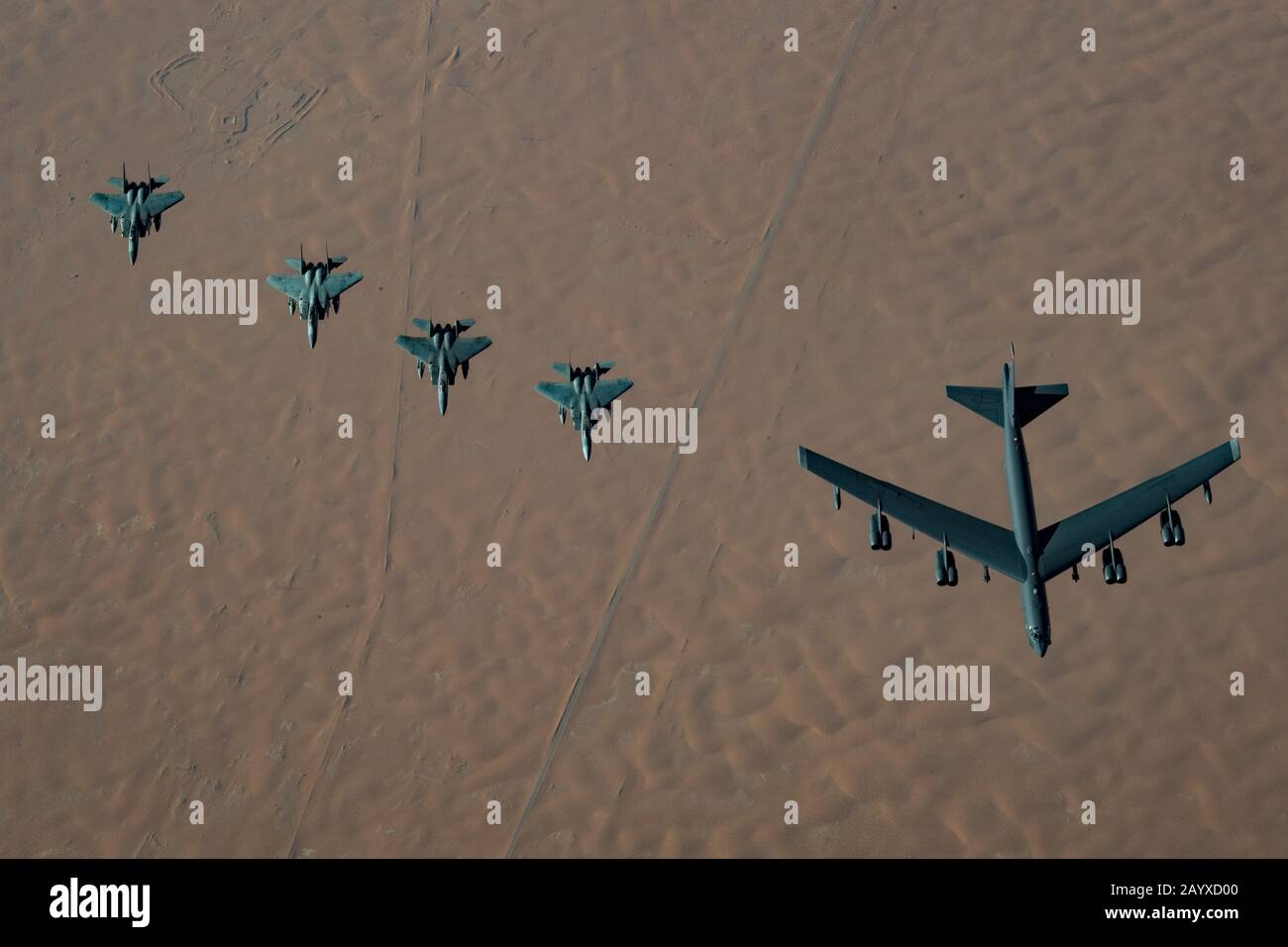 A U.S. Air Force B-52H Stratofortress strategic bomber accompanied by four Saudi Arabian F-15C Eagle fighter jets, conducts a low pass over Prince Sultan Air Base November 1, 2019 in Al Kharj, Saudi Arabia. Stock Photo