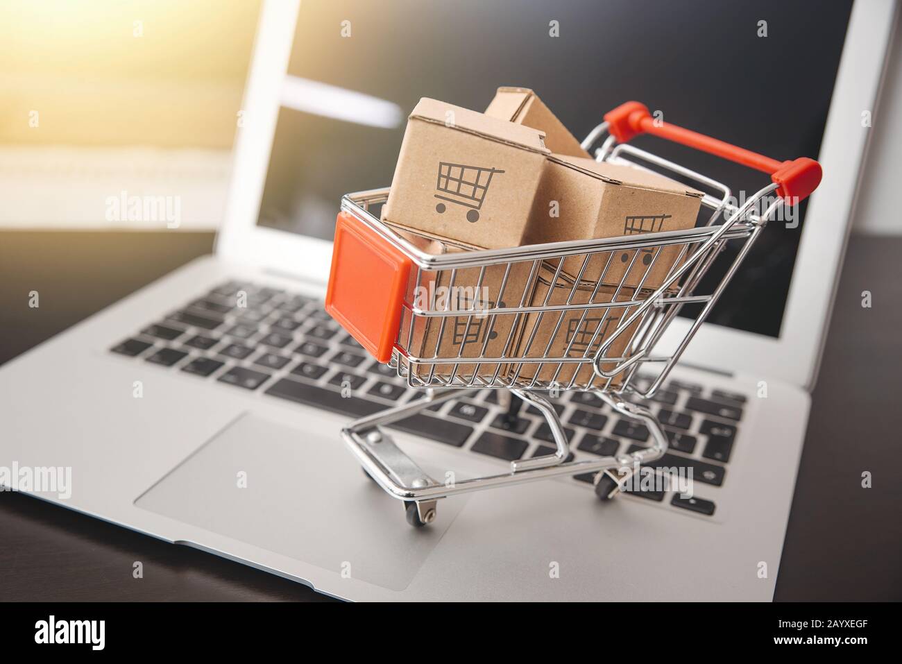 e-commerce, shopping trolley with paper boxes. Trade, selling via internet Stock Photo