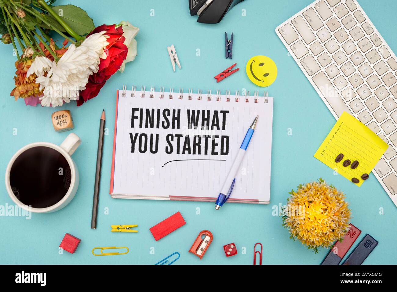 Finish what you started quote with office stationery items Stock Photo