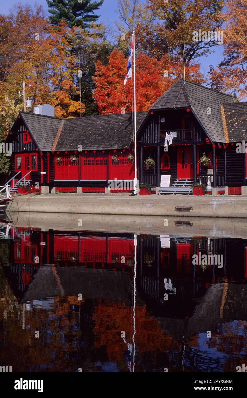 The boat house of the Chateau Montebello is reflecting in the Ottawa