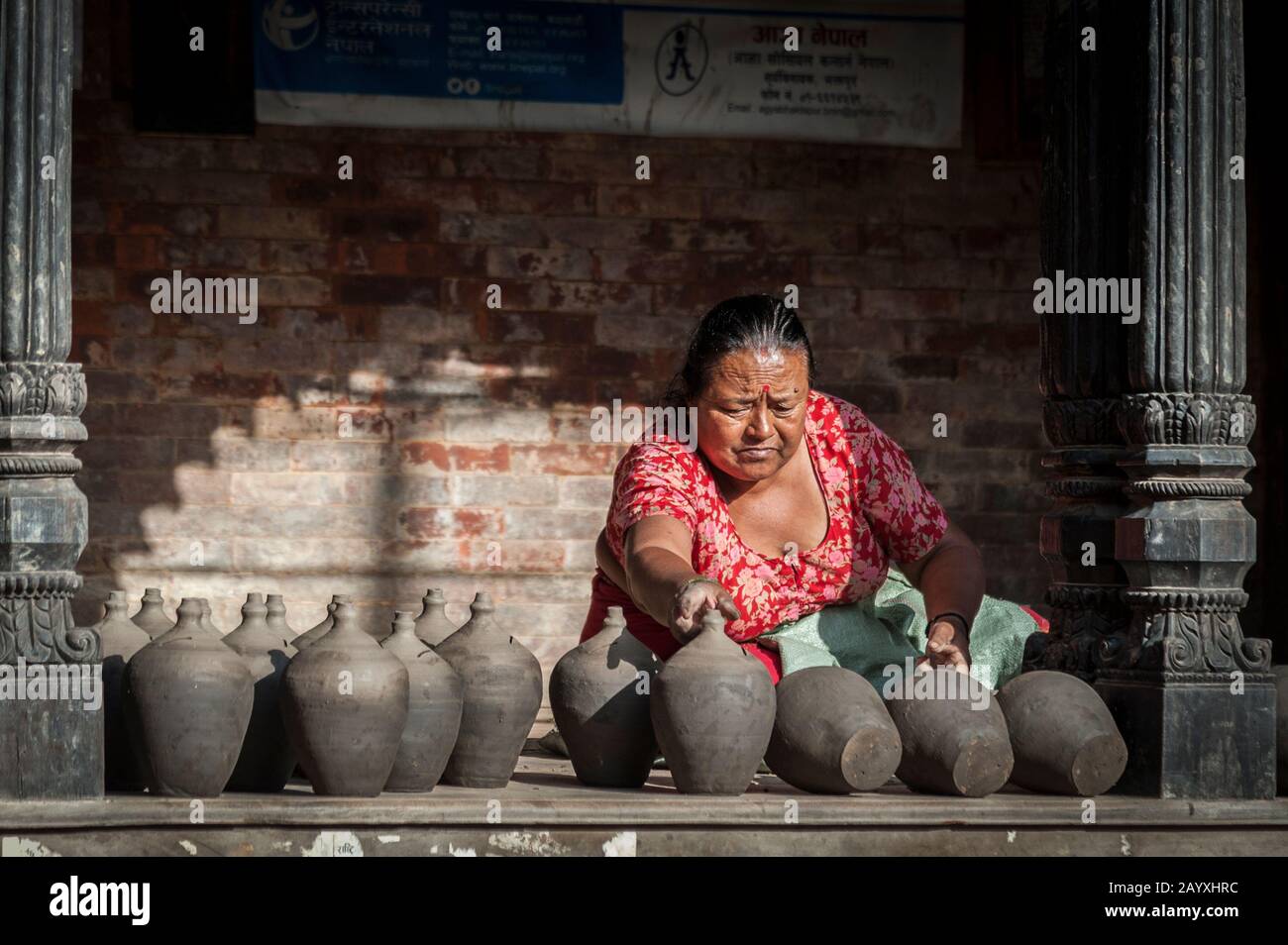 Nepalese woman making pottery in Pottery square, a public square full