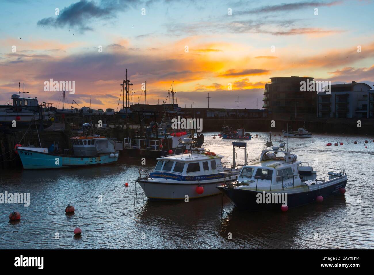 West Bay, Dorset, UK.  17th February 2020.  UK Weather.    View of the harbour at sunset at West Bay in Dorset.  Picture Credit: Graham Hunt/Alamy Live News Stock Photo