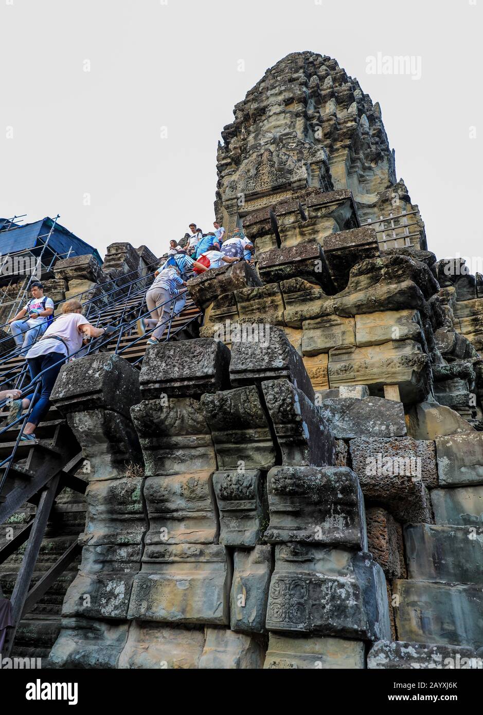 Tourists climbing a tower at the Angkor Wat temple complex, Siem Reap, Cambodia, Asia Stock Photo