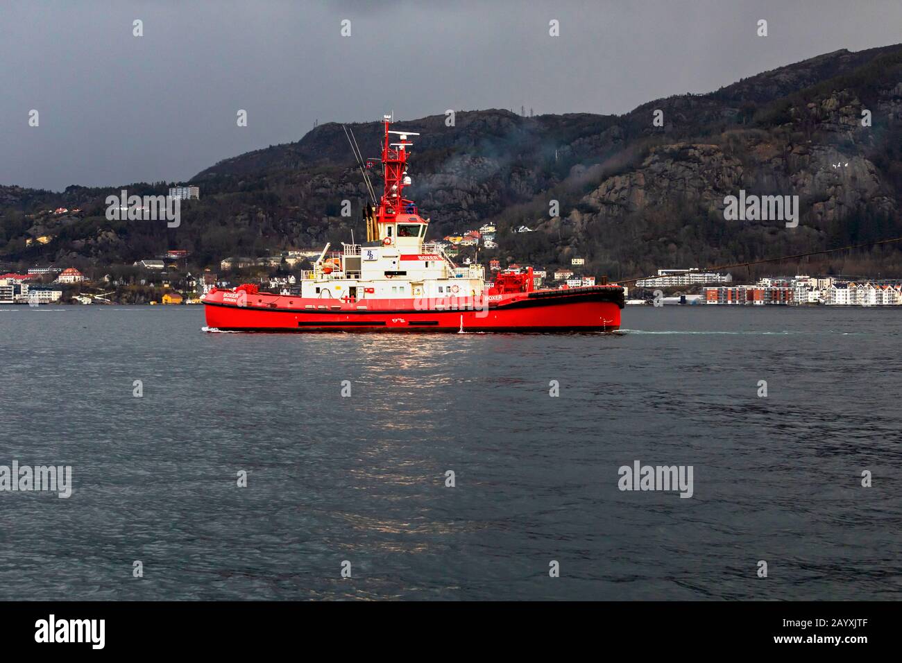 Tug boat Boxer at Byfjorden, outside port of Bergen, Norway. Assisting a departing vessel Stock Photo