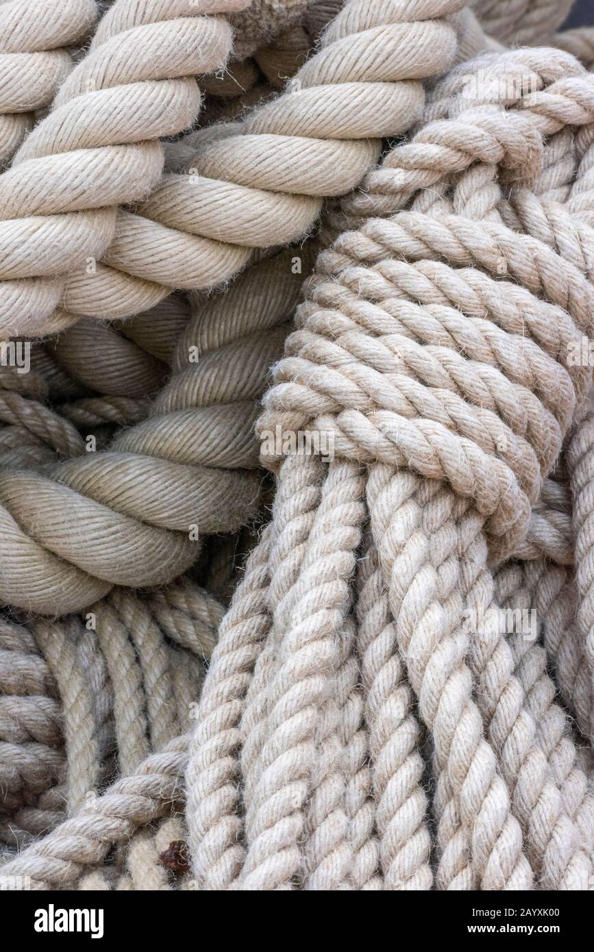 Thick ropes used for tying up yachts, boats and ships in a. Nautical or marine maritime setting. Stock Photo