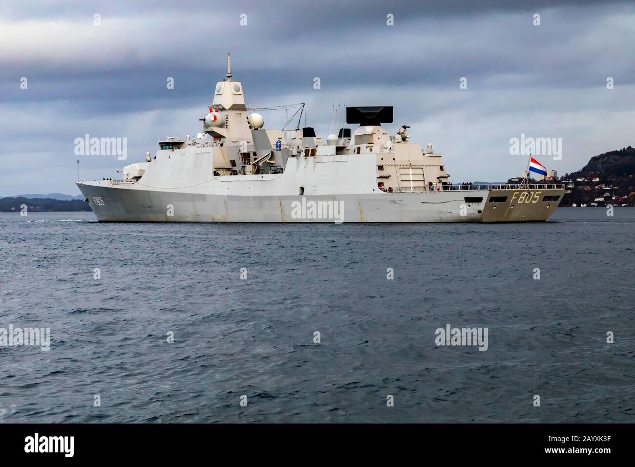 Dutch warship, frigate HNLMS Evertsen F805, departing from the port of Bergen, Norway. A dark and rainy winter day Stock Photo