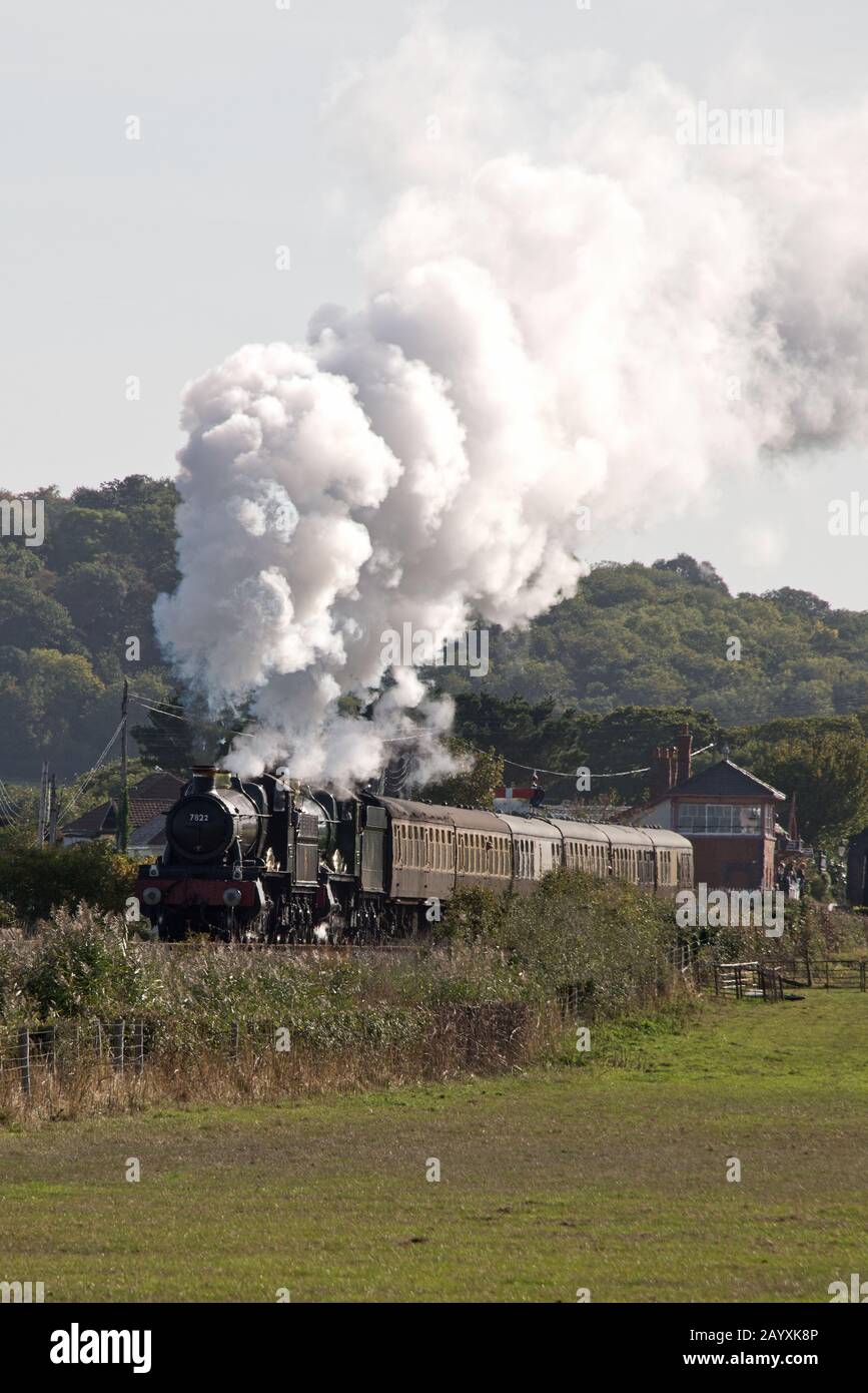 A double header train comprising of 6960 Raveningham Hall and 7822 Foxcote Manor pulling a rain toward Minehead on the West Somerset Railway. Stock Photo