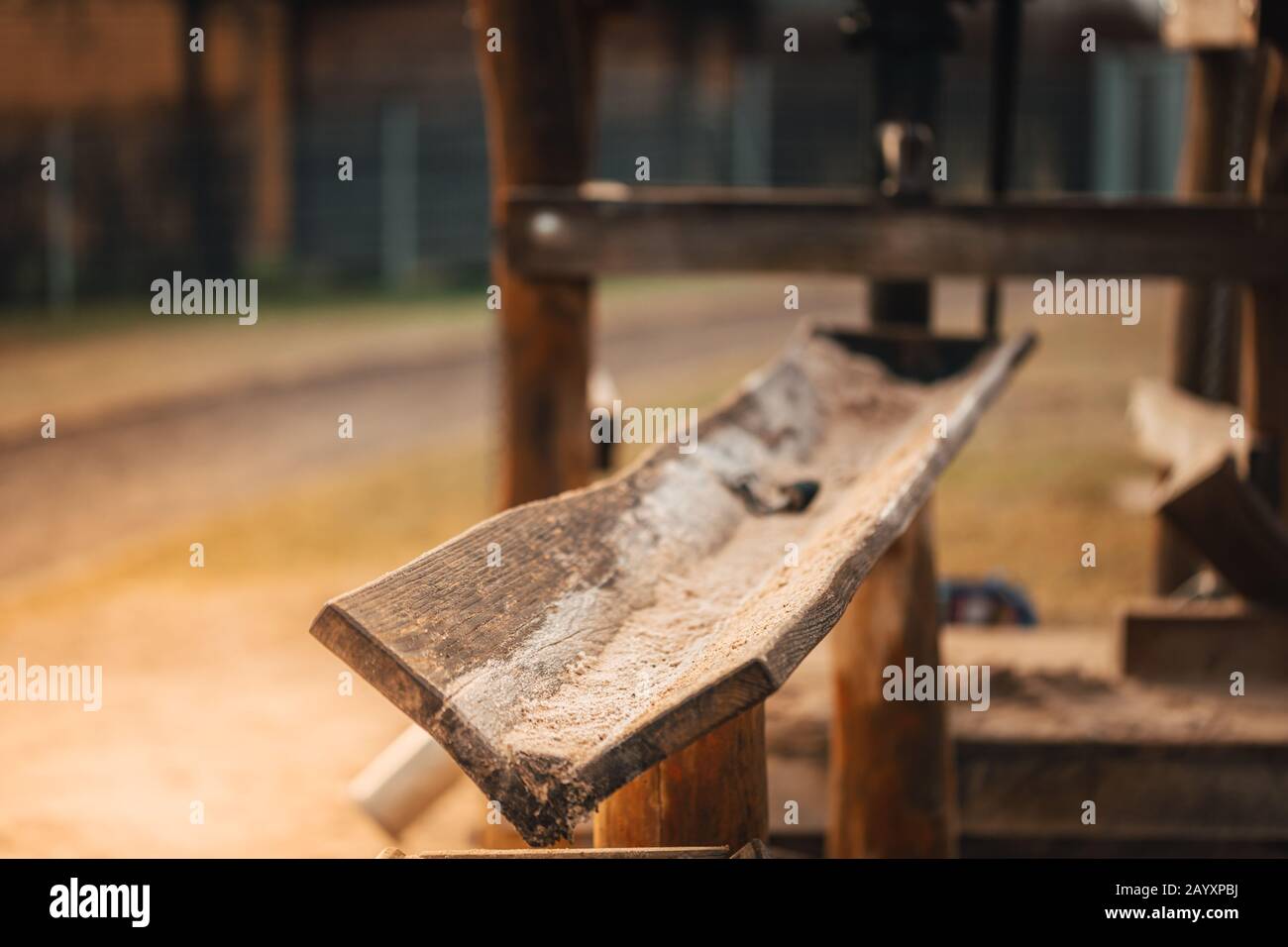 Wooden water pipe with sand on a playground for children. Stock Photo