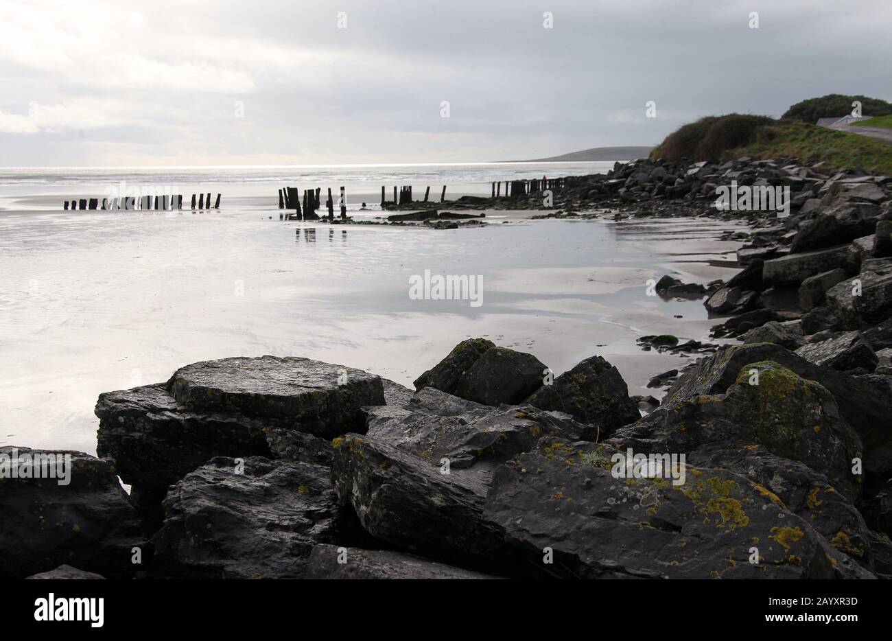 Remains of the old pier at Harbour View Beach in Southern Ireland Stock Photo