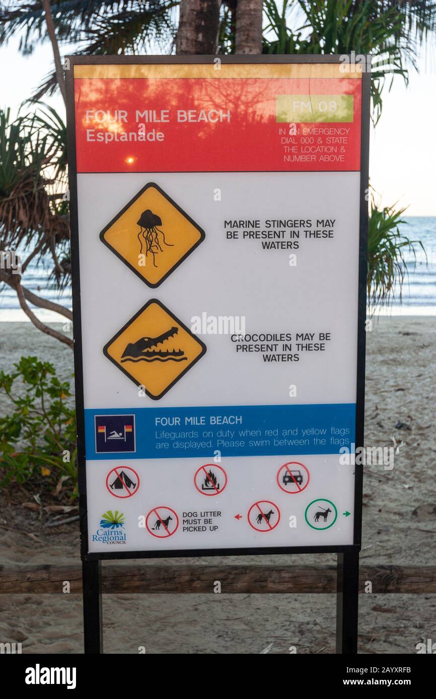 Sign in Four Mile Beach warning about marine stingers and crocodiles, Port Douglas, Queensland, Australia Stock Photo