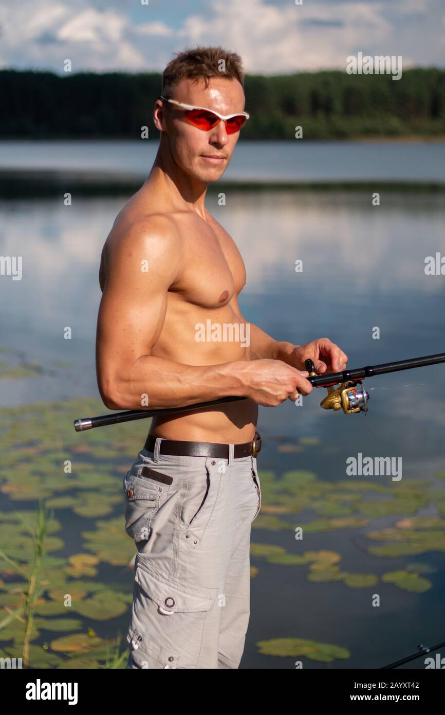 https://c8.alamy.com/comp/2AYXT42/a-beautiful-man-with-a-bare-cake-with-a-fishing-rod-2AYXT42.jpg