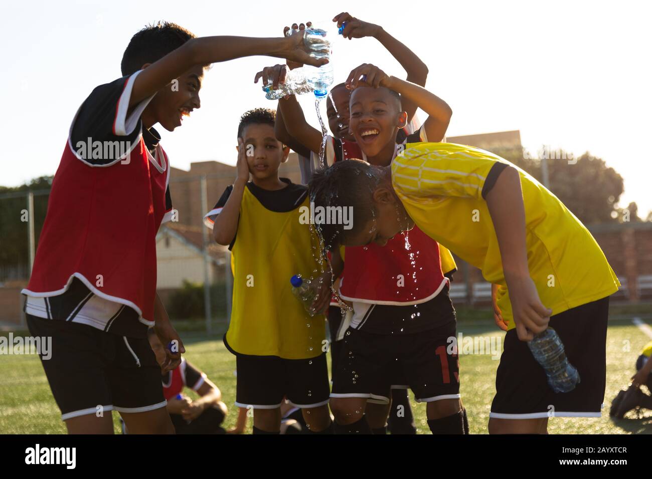 Soccer players putting water on their friend head Stock Photo