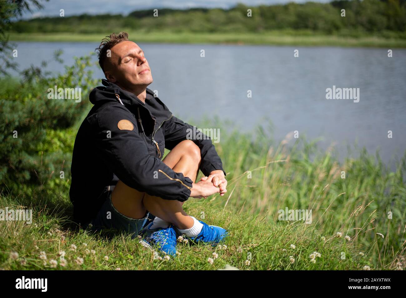A man on the shore of the lake. Stock Photo