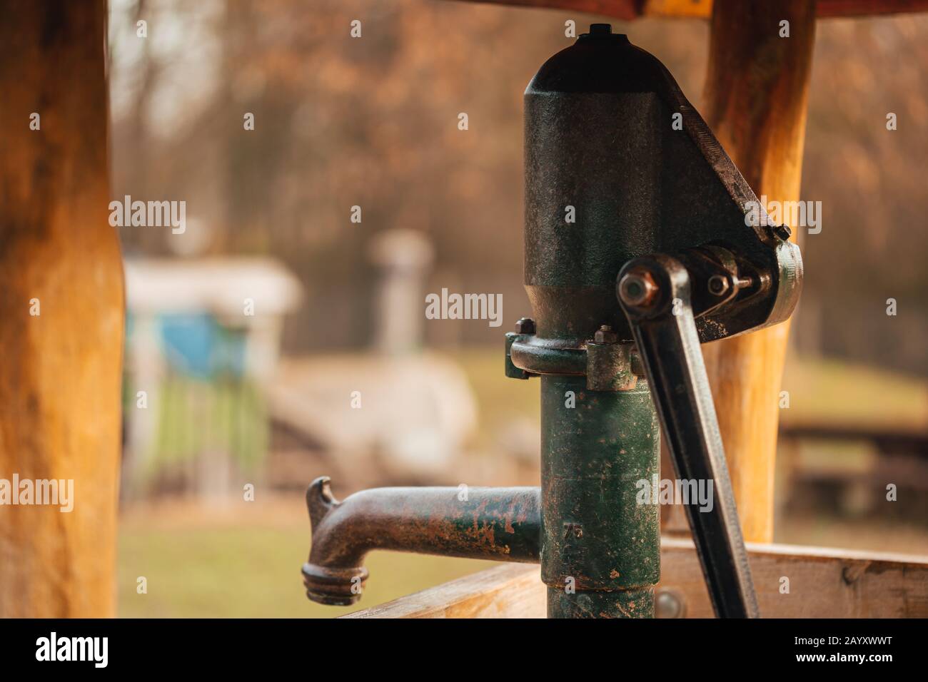 Old and rusty water pump on a playground for children. Stock Photo