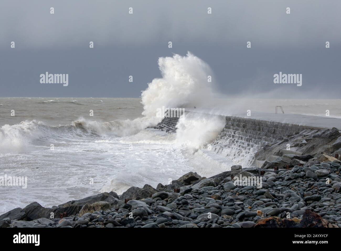 Gale force winds gusting at over 60mph and the morning’s high tide combine, bringing huge waves sweeping across the Irish Sea to batter Aberystwyth. Stock Photo