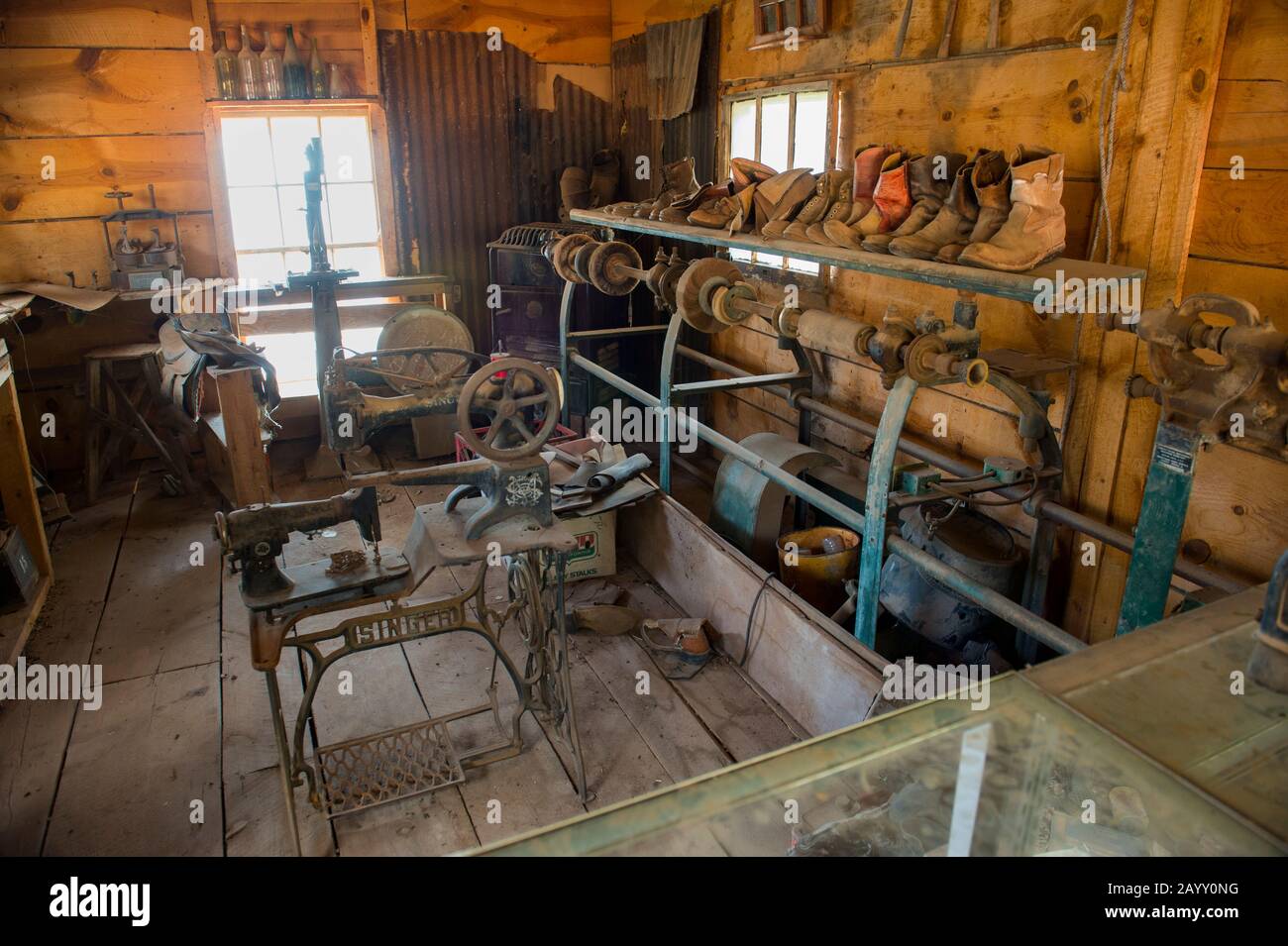 The interior of a shoemaker shop with an old Singer sewing machine at