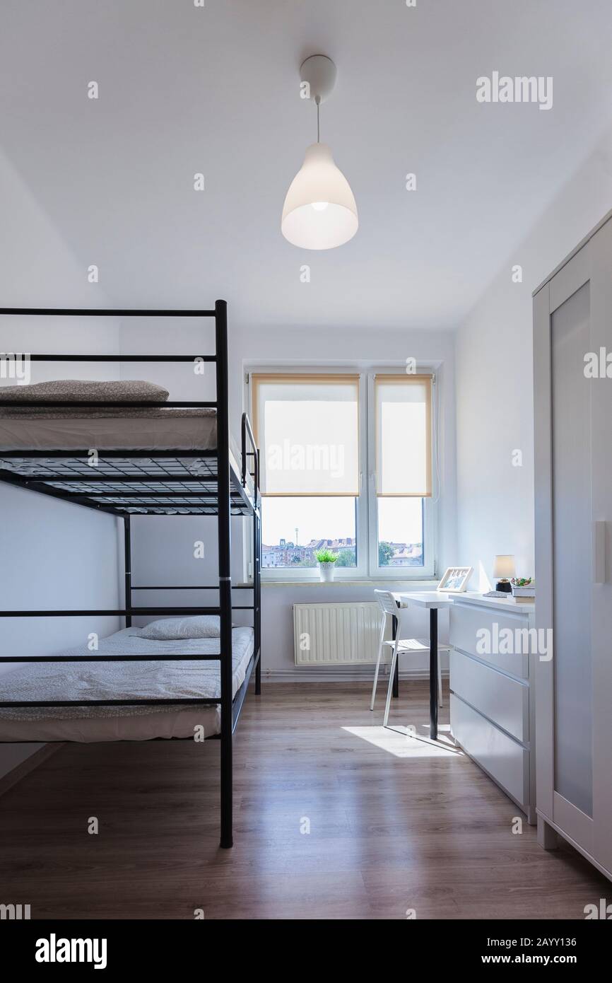 Real bedroom with two metal, black beds.The beds is bunk bed Stock