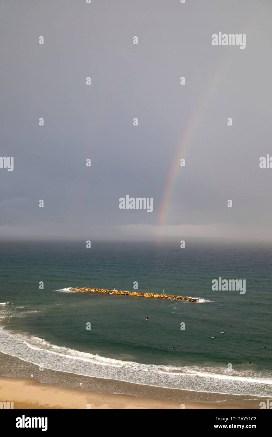 Rainbow over Frishman beach and artificial offshore breakwater in the Mediterranean Sea, Tel Aviv . Stock Photo