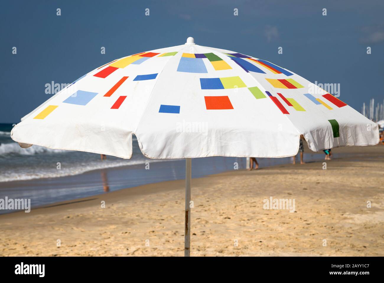 Beach umbrella on the sand along the Mediterranean Sea Stock Photo