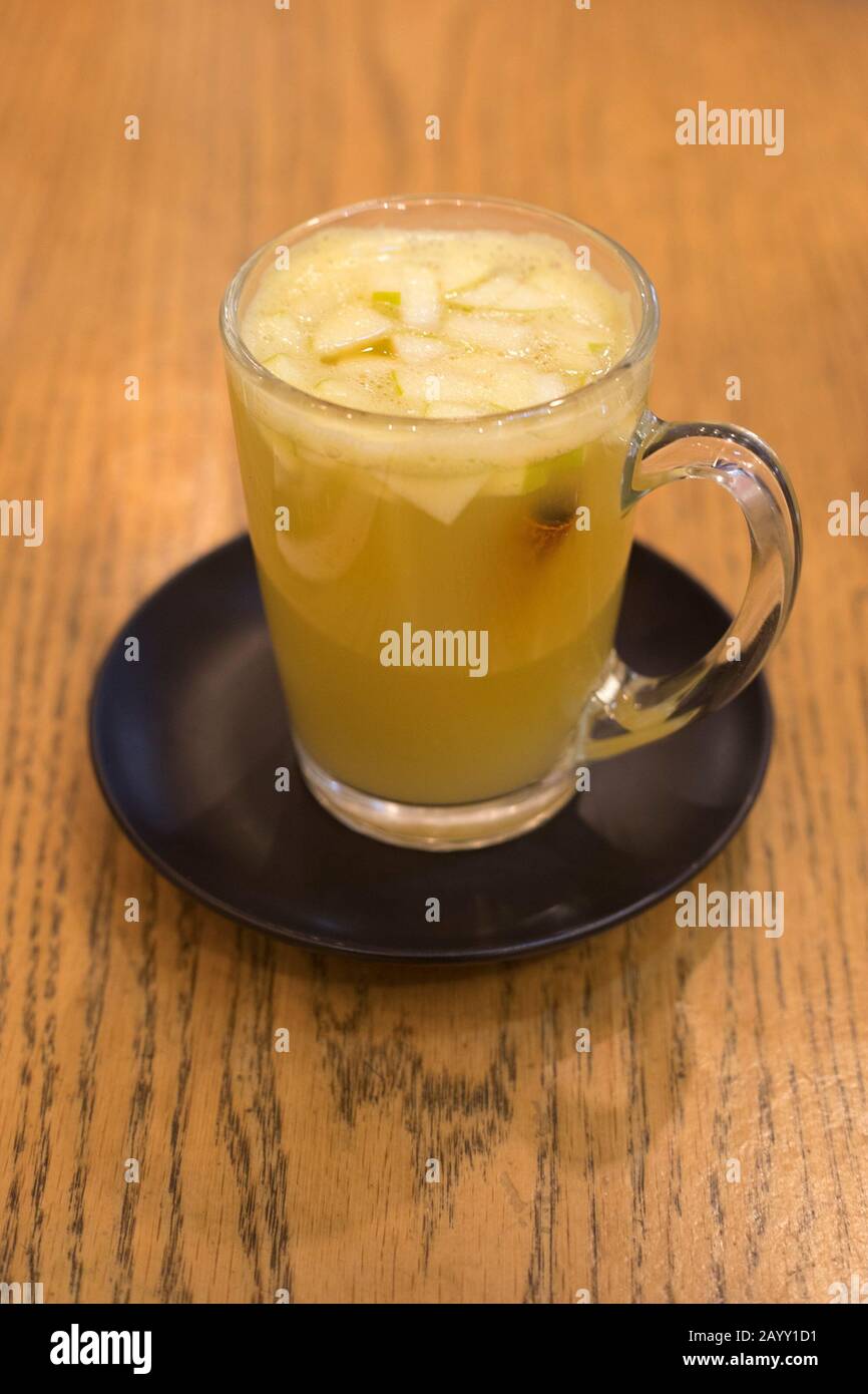 Fresh squeezed apple juice with kaffir lime and cinnamon stick at Anastasia Cafe in Tel Aviv, Israel Stock Photo