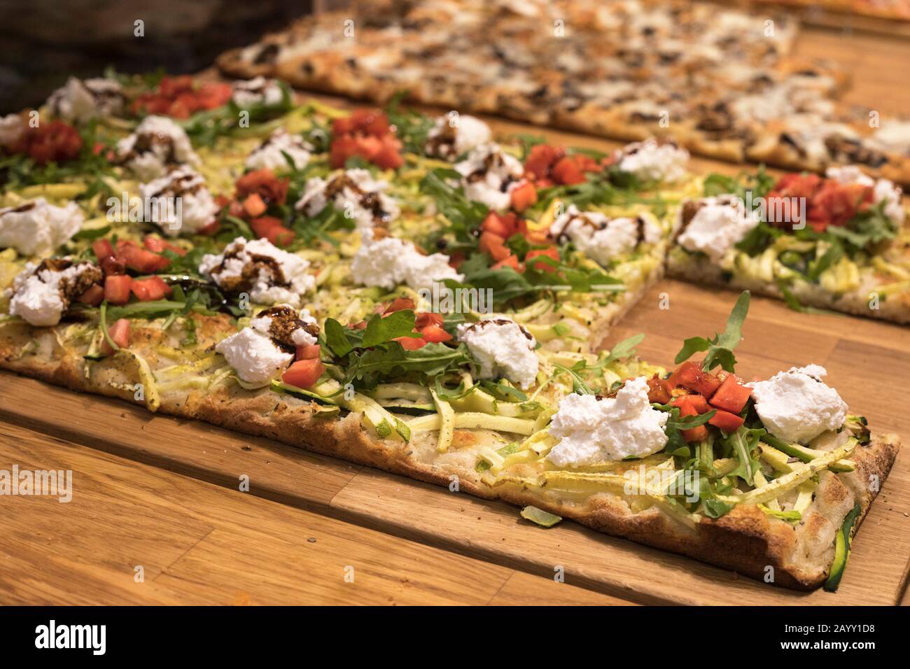 Pizza al taglio with cheese, tomatoes, zucchini and greens at GaliRoma