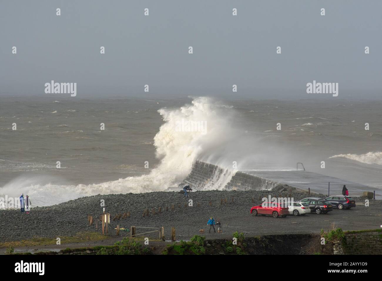 Gale force winds gusting at over 60mph and the morning’s high tide combine, bringing huge waves sweeping across the Irish Sea to batter Aberystwyth. Stock Photo