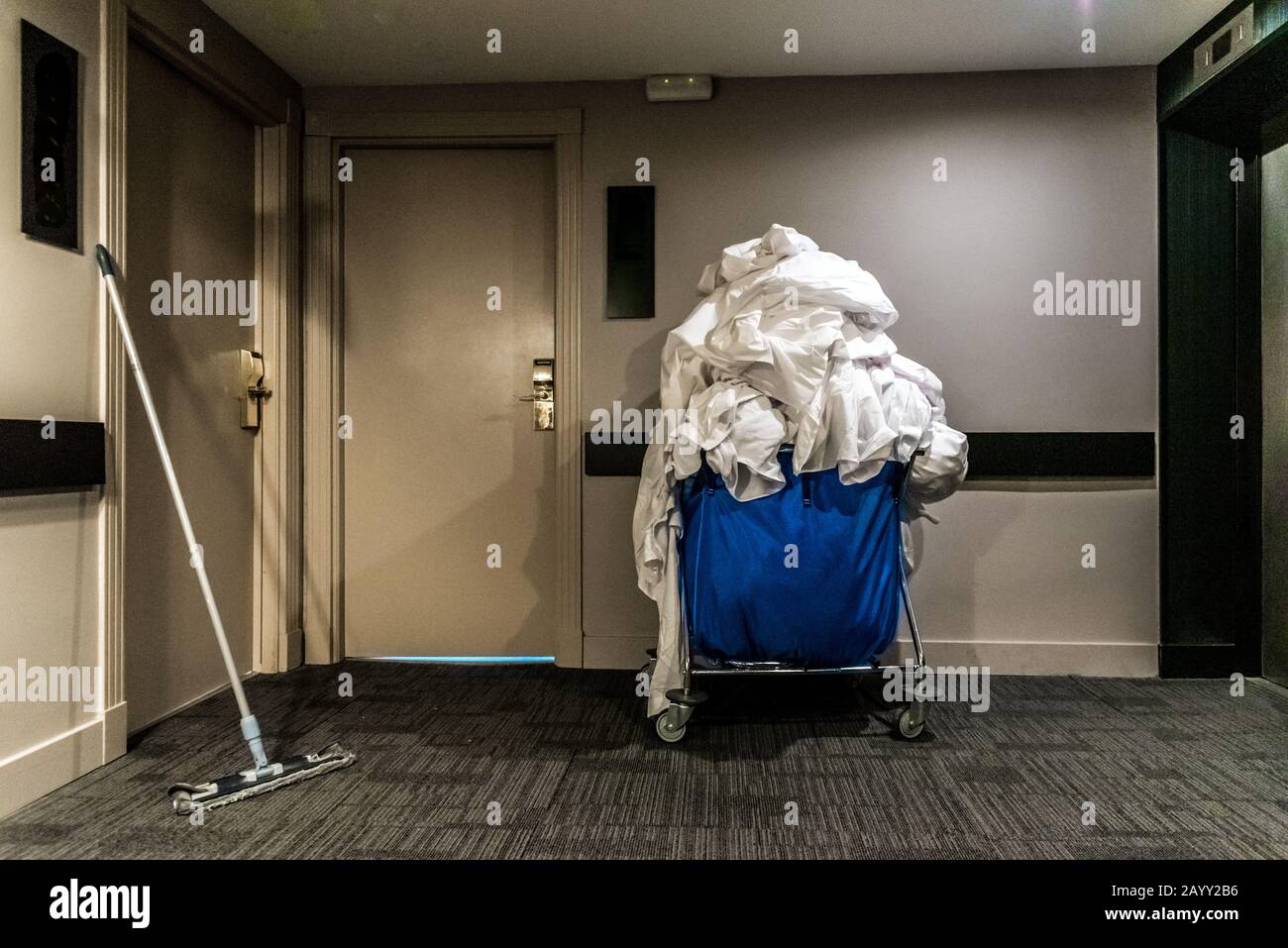 Trolley with dirty clothes in the corridor of a hotel. Stock Photo
