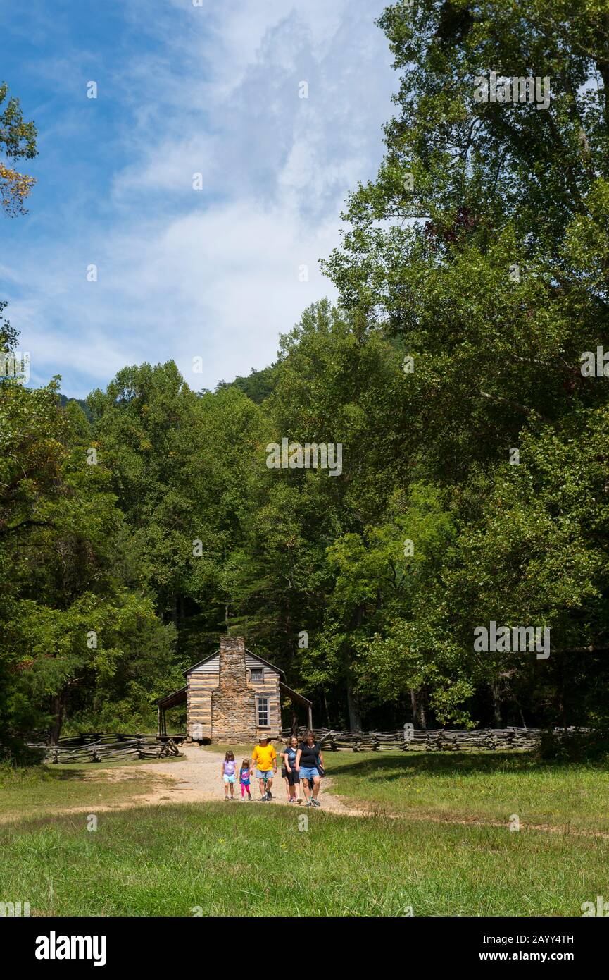 People coming from visiting the John Oliver cabin from the 1820s in Cades Cove, Great Smoky Mountains National Park in Tennessee, USA. Stock Photo