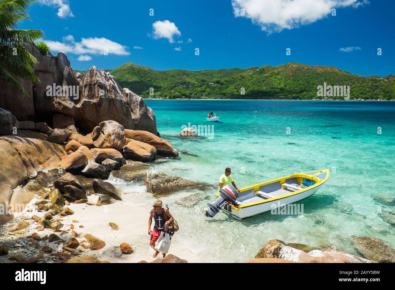 Snorkellers arriving at St Pierre Islet from Anse Volbert, Praslin Island, Seychelles Stock Photo