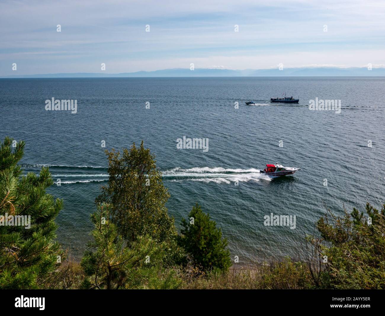 Speedboat passing by Kamennyy Beach, Lake Baikal, Irkutsk Region, Siberia, Russia Stock Photo