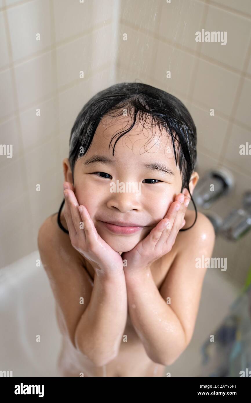 Cute four year old girl taking shower Stock Photo Alamy