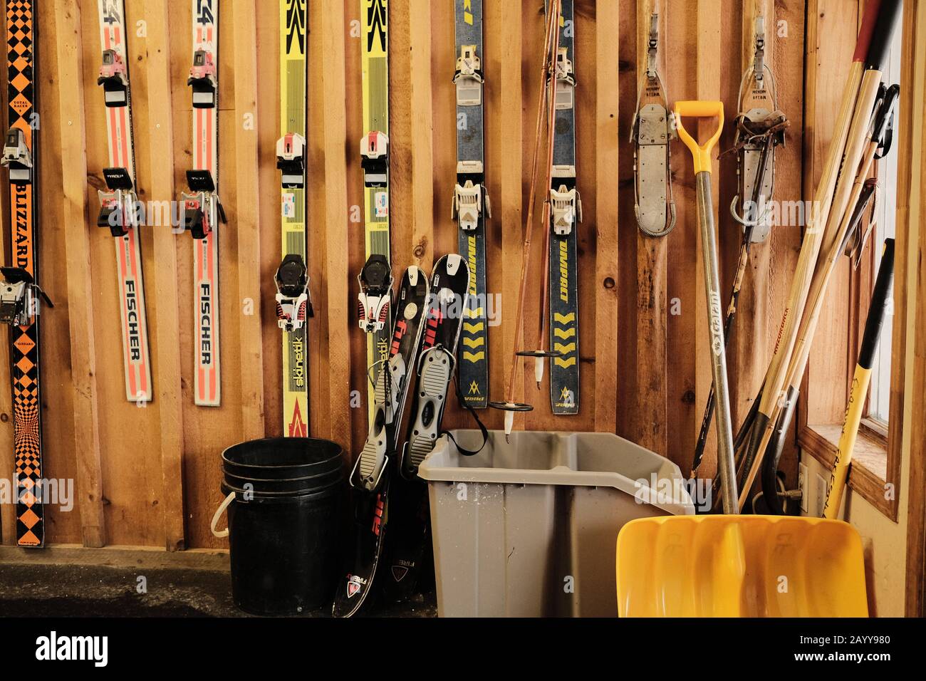 Skis though the ages - progression of historic skis hanging from a wooden chalet wall, Ottawa, Ontario, Canada. Stock Photo
