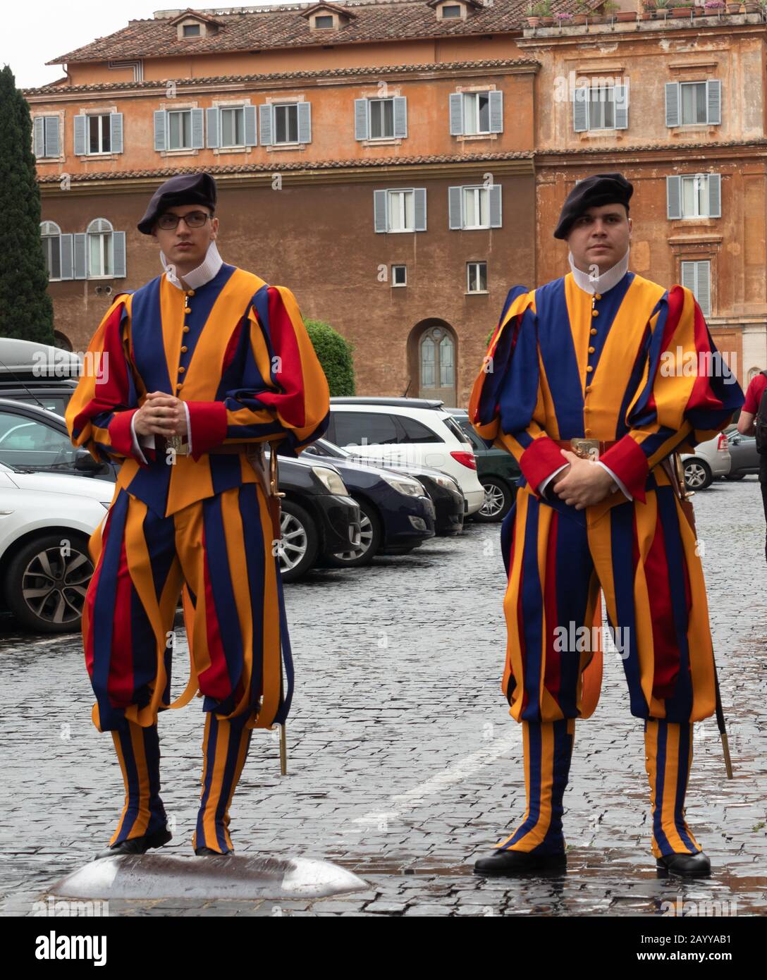 Two Swiss Guard or Pontifica in renaissance blue, red, orange and yellow dress uniform at Vatican City Rome Italy. Stock Photo