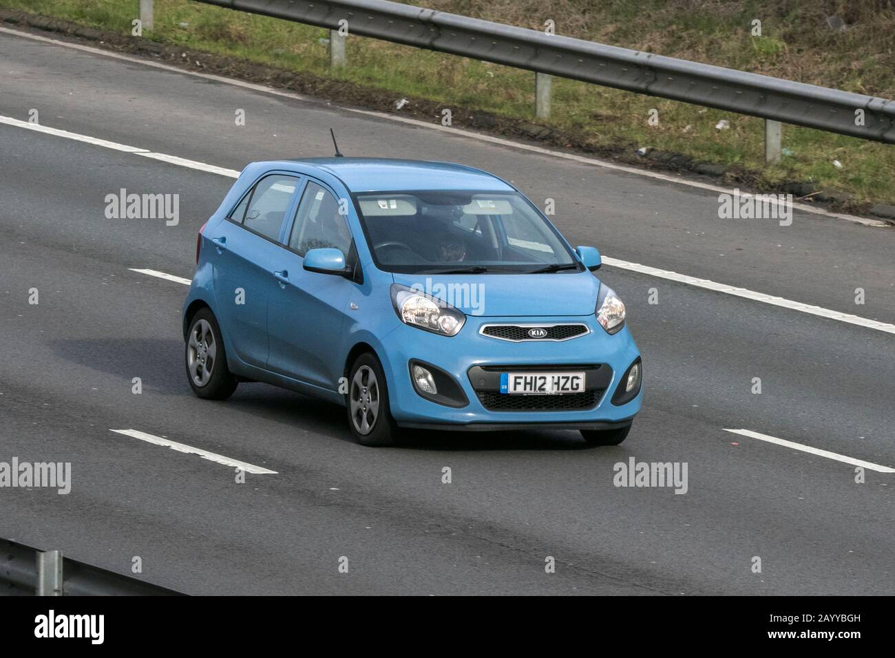 2012 blue Kia Picanto 1; vehicle movement driving on the M6 motorway near Preston in Lancashire, UK Stock Photo