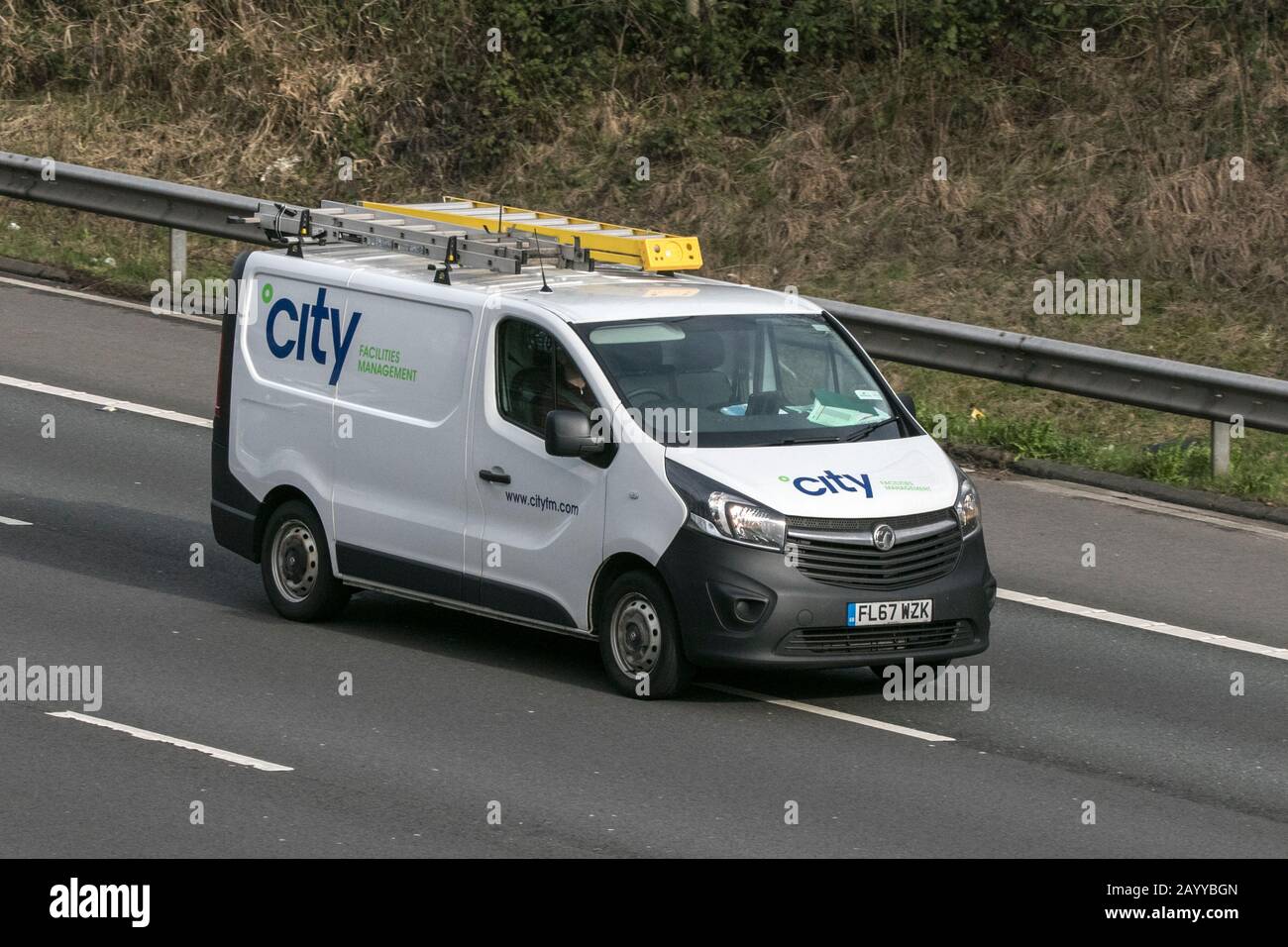 A City Facilities Management Vauxhall Vivaro panel van vehicle movement driving on the M6 motorway near Preston in Lancashire Stock Photo