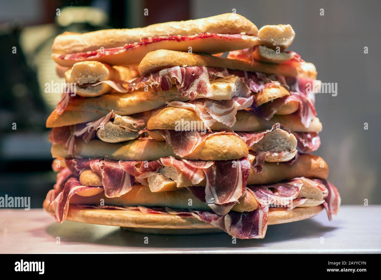 Plate with lots of Serrano ham sandwiches on top of each other Stock Photo