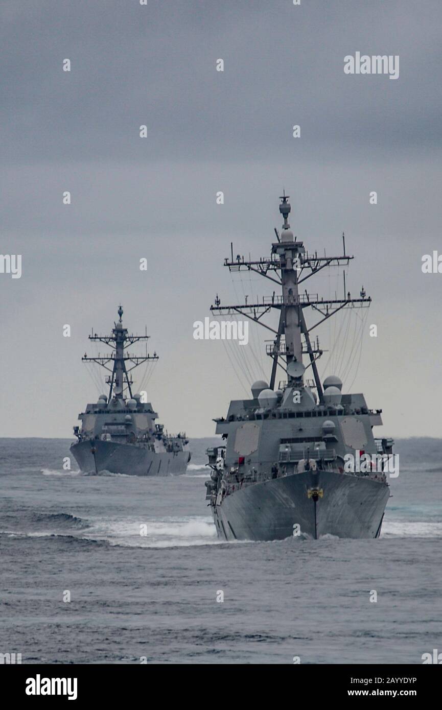 A U.S. Navy Arleigh Burke-class guided-missile destroyers USS Rafael Peralta and USS John Finn, right, during routine training operations December 7, 2019 in the Pacific Ocean. Stock Photo