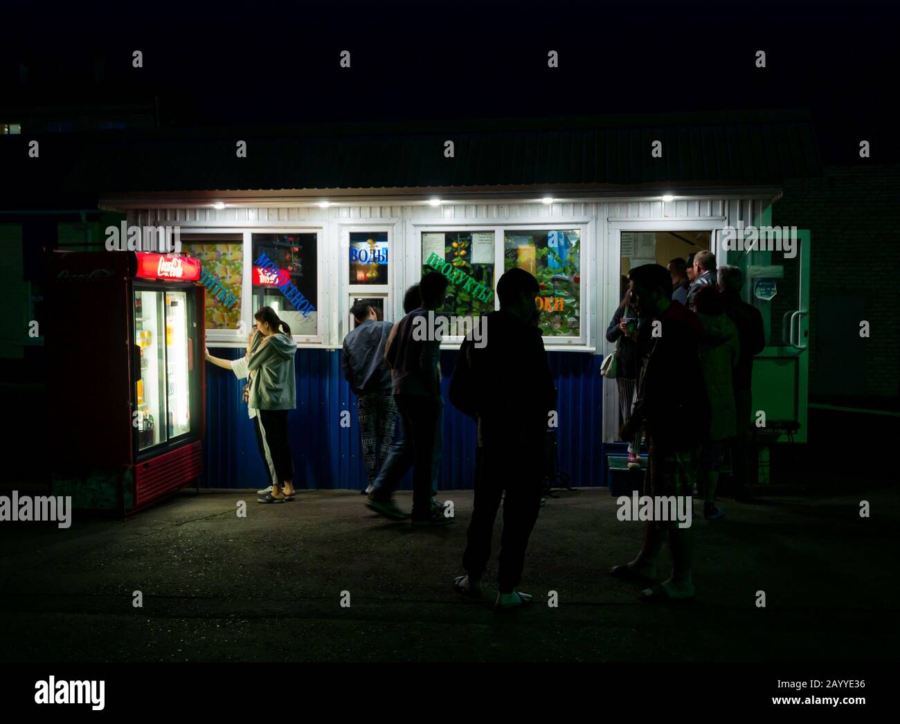 Passengers on station platform food kiosk & vending machine at night, Zima Railway Station, Trans-Siberian Railway route, Siberia, Russian Federation Stock Photo