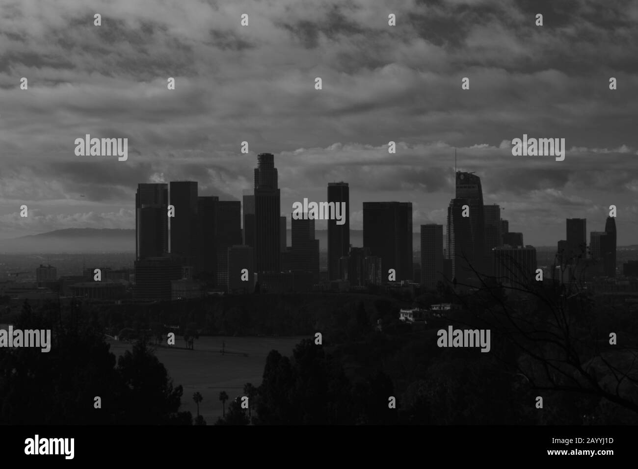 Iconic Los Angles Skyline Against Cloudy Sky In Black And White Stock Photo