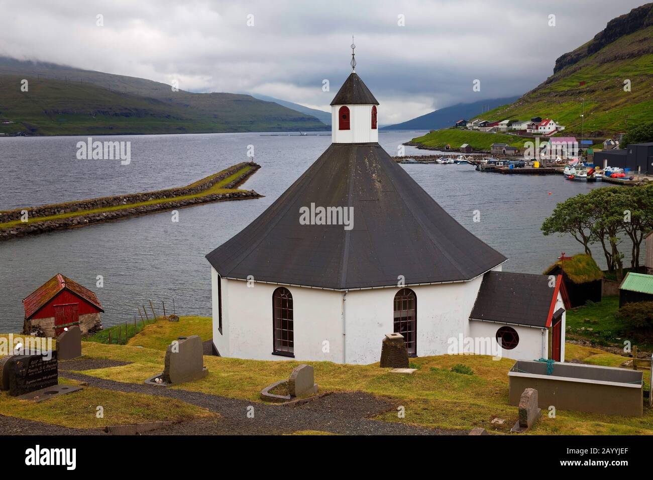 octagonal church in the litte village of Haldarsvik with view onto the Atlanic Ocean, Faroe Islands, Streymoy, Haldarsvik Stock Photo